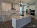Gourmet kitchen with stainless steel appliances, a large island with a sink, and modern lighting at 2069 Fordhill St, Rock Hill, SC 29732