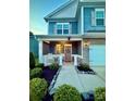 Inviting front porch with rocking chairs and manicured landscaping for a cozy curb appeal at 243 Kerri Dawn Ln, Locust, NC 28097