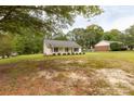 Well-manicured lawn surrounds a lovely single-story home with traditional design elements at 2460 Prince Dr, Lancaster, SC 29720
