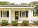 Close-up of a charming front porch with decorative touches and a welcoming entrance at 2460 Prince Dr, Lancaster, SC 29720