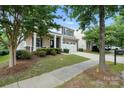 Charming two-story home with a covered front porch, stone accents, and an attached two-car garage at 3020 Fallondale Rd, Waxhaw, NC 28173