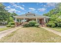 Classic brick home with a spacious front porch and beautifully maintained yard at 330 S Ellis St, Salisbury, NC 28144