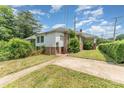 Exterior view of the house, featuring brick accents and a small, fenced in yard at 330 S Ellis St, Salisbury, NC 28144