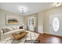 A bright living room featuring a large window, modern chandelier, and ample space at 3333 Cole Mill Rd, Charlotte, NC 28270