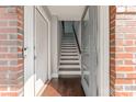 Inviting entryway with hardwood floors, leading to a staircase with a modern railing, offering a glimpse of the upper floors at 3643 Vallette Ct, Charlotte, NC 28203