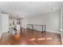 Open-concept living area with hardwood floors, modern railing, and natural light, perfect for entertaining and relaxation at 3643 Vallette Ct, Charlotte, NC 28203