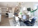 Open concept dining room with modern chandelier, wood table, and view of the stylish kitchen at 4715 Formation Dr # 047, Lancaster, SC 29720