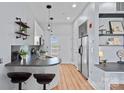 Compact kitchen featuring sleek countertops, stainless steel appliances, and wood floors at 514 W 10Th St # 302, Charlotte, NC 28202