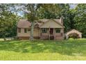 Charming single-Gathering home with a welcoming front porch, mature trees, and a detached garage at 544 Hicks Creek Rd, Troutman, NC 28166