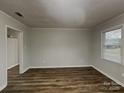 Bright living room with wood floors and natural light streaming through the window, creating an inviting space at 6513 Old Post Rd, Charlotte, NC 28212