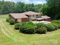 Expansive backyard with a pool surrounded by lush greenery, offering a private outdoor retreat at 8417 Rolling Hills Ave, Hickory, NC 28602