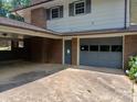 Attached garage and carport with brick columns, providing ample parking and storage at 8417 Rolling Hills Ave, Hickory, NC 28602