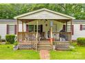 Inviting covered porch featuring a seating area and charming decorative accents at 10435 Silver Mine Rd, Fort Mill, SC 29707