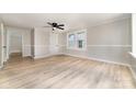 Bright living room featuring neutral paint, modern ceiling fan, and natural light pouring in from large windows at 105 Mcgill Nw Ave, Concord, NC 28025