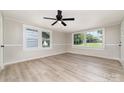 Spacious living room with large windows, modern ceiling fan, and stylish flooring perfect for entertaining at 105 Mcgill Nw Ave, Concord, NC 28025