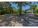 The home features a well-maintained gravel driveway and lush greenery at 1239 Mac Ln, Stanley, NC 28164