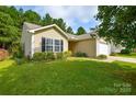 Inviting home with a lush green lawn, manicured bushes and a well-kept garden at 1312 Shenandoah Cir, Rock Hill, SC 29730