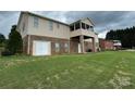 Spacious backyard featuring a patio, screened porch, and a well-maintained lawn on the basement-level home at 1519 Midland Dr, Hudson, NC 28658