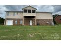 Back exterior featuring a screen porch and patio, with large lawn and brick and vinyl siding at 1519 Midland Dr, Hudson, NC 28658