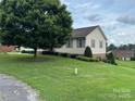 View of the left side of the house with a lawn and a tree at 1519 Midland Dr, Hudson, NC 28658