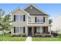 Inviting two-story house with a combination of neutral siding and brick accents, complemented by lush green grass at 1522 Tuckers Glenn Dr, Rock Hill, SC 29732