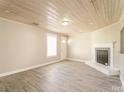 Bright living room featuring a modern fireplace, light wood flooring, and a unique wood plank ceiling at 1522 Tuckers Glenn Dr, Rock Hill, SC 29732
