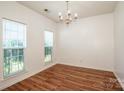 Dining room featuring hardwood floors, bright lighting, and views of the front yard at 198 Devon Forest Dr, Mooresville, NC 28115