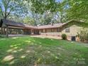 The home features a spacious backyard with a covered area great for outdoor entertaining at 2104 Stoneyridge Dr, Charlotte, NC 28214