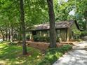 A one story home with a beautiful lawn and a brick walkway leading to the entrance at 2104 Stoneyridge Dr, Charlotte, NC 28214