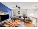 Cozy living room featuring a stone fireplace, plush sectional sofa, and modern ceiling fan at 2116 Bon Villa Way, Fort Mill, SC 29708