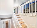 Bright staircase with white rails and wood treads, leading to the upper level of the home at 2116 Bon Villa Way, Fort Mill, SC 29708