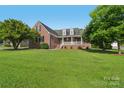 Traditional brick home showcasing a well-manicured lawn and welcoming front porch at 2411 Stoney Run Dr # 13, Oakboro, NC 28129