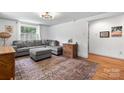 Bright living room featuring a comfortable gray sectional and hardwood flooring at 2623 Ne 13Th Ne St, Hickory, NC 28601