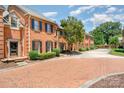 Beautiful brick townhomes with well-maintained landscaping along a brick-paved street at 2825 Sharon View Rd, Charlotte, NC 28210