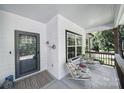 Inviting front porch with seating area featuring comfortable chairs and charming decor on a sunny day at 333 Anne Ave, Waxhaw, NC 28173