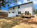 Spacious backyard with a wooden deck and a newly installed white picket fence at 3926 Litchfield Rd, Charlotte, NC 28211