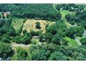 Beautiful aerial shot of the property's cleared land, surrounded by lush greenery, offering privacy and potential at 4171 Leatherman Rd, Vale, NC 28168