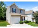 Charming two-story home with tan siding, red shutters, a garage, and a well-manicured front lawn at 437 Danielle Way, Fort Mill, SC 29715
