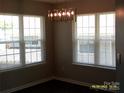 Cozy dining area with natural light from multiple windows and a contemporary light fixture at 5855 Amity Springs Dr, Charlotte, NC 28212