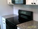 Kitchen showcases stainless steel appliances and sleek herringbone backsplash at 5855 Amity Springs Dr, Charlotte, NC 28212