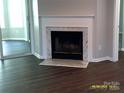 Bright living room features a marble fireplace and dark wood flooring, a cozy focal point at 5855 Amity Springs Dr, Charlotte, NC 28212