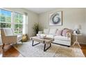 Bright living room with natural light, modern decor, plush seating, and stylish rug at 6319 Welford Rd, Charlotte, NC 28211