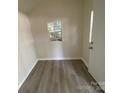 Interior of the shed with gray vinyl flooring and a window at 709 Falls Church Rd, Charlotte, NC 28270