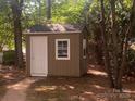 Outdoor storage shed with clean white door and window at 709 Falls Church Rd, Charlotte, NC 28270