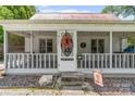 Inviting screened-in front porch with decorative wreath and charming details at 727 W Main Street Ext, Lincolnton, NC 28092