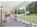 Relaxing screened-in front porch with seating area, perfect for enjoying the outdoors at 727 W Main Street Ext, Lincolnton, NC 28092