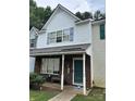 Traditional townhouse featuring brick accents, white siding and a covered front porch entrance at 7857 Petrea Ln, Charlotte, NC 28227