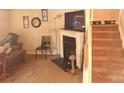 Inviting living room with a fireplace and staircase to the upper level at 7857 Petrea Ln, Charlotte, NC 28227