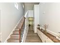Bright foyer showcasing hardwood floors, a staircase, and elegant console table with decorations at 8524 Loxton Cir, Charlotte, NC 28214