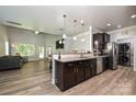 Open kitchen with dark wood cabinets, stainless steel appliances, and a view to the living room at 8524 Loxton Cir, Charlotte, NC 28214